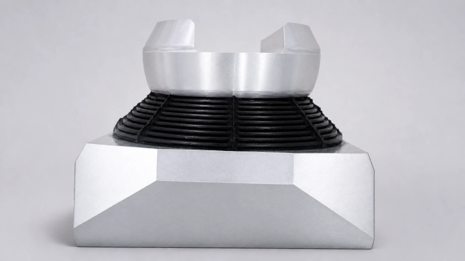 Development-stage spherical elastomeric bearing sample with laminated metal and elastomer structure