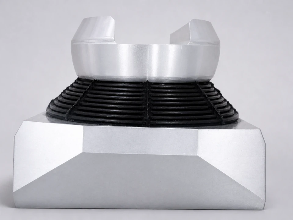 Development-stage spherical elastomeric bearing sample with laminated metal and elastomer structure